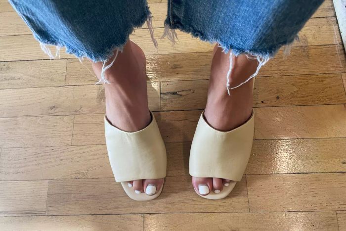 A model wearing the Aerosoles Entree Shoe, standing on a wooden floor