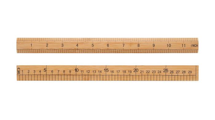 A 12-inch or 30-centimeter Beige Wooden Ruler Isolated on a White Background