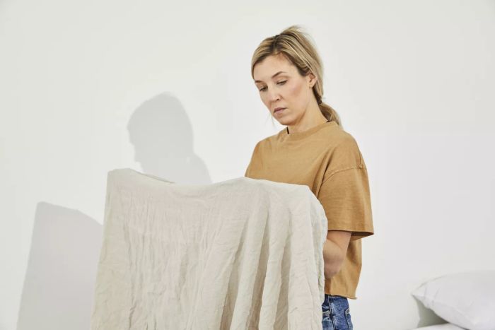 A person holding the Parachute Linen Sheet