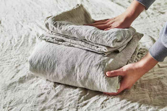 A person folding the Parachute Linen Sheet during testing