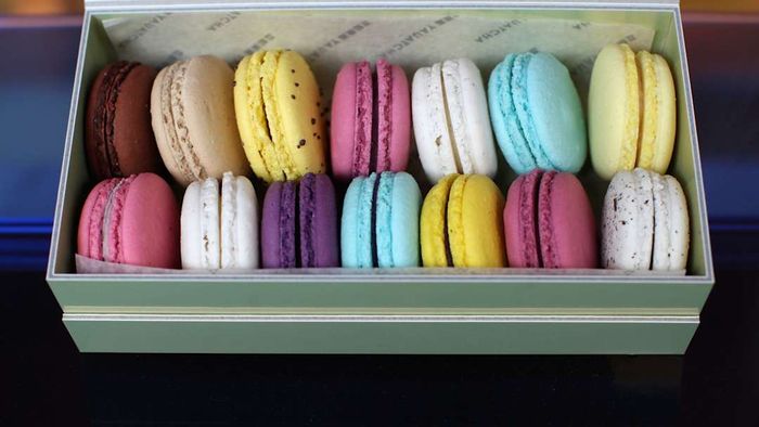 A box filled with a variety of vibrant macarons.