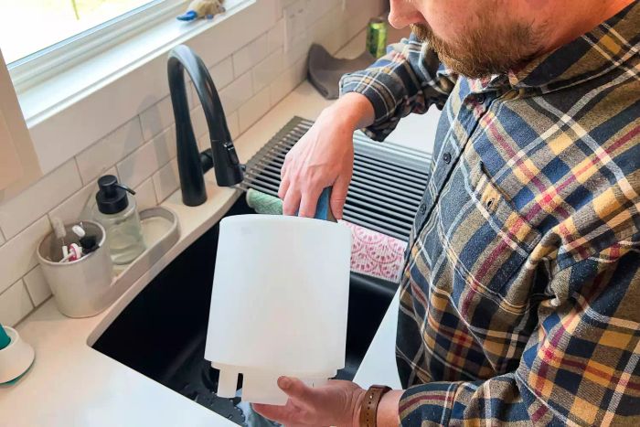 A person is cleaning the Levoit .8 Gallon Top-Filled Ultrasonic Cool Mist Humidifier