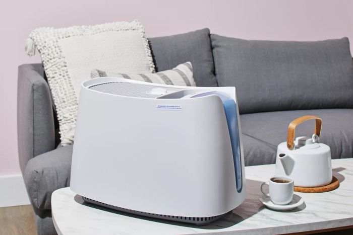 The Honeywell Cool Moisture Humidifier is shown placed on a coffee table