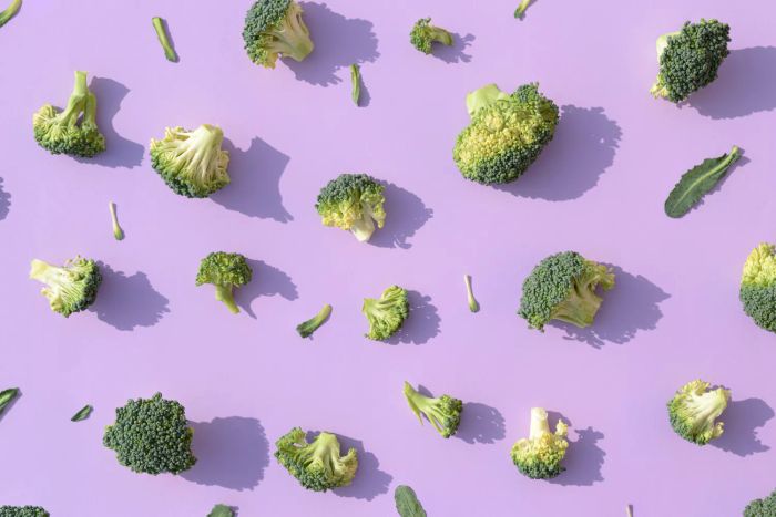 Fresh broccoli displayed on a vibrant purple backdrop, symbolizing organic and healthy eating. Perfect for aesthetic wallpapers or health-conscious themes.
