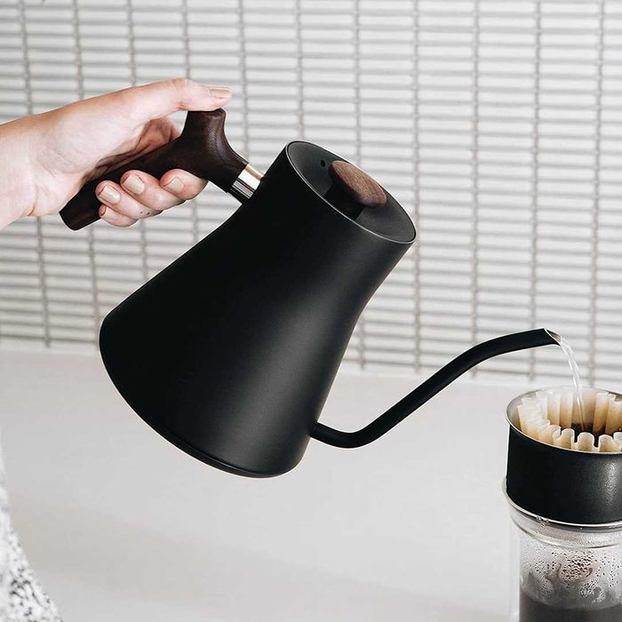 Fellow Stagg electric pour-over kettle positioned above a coffee mug.