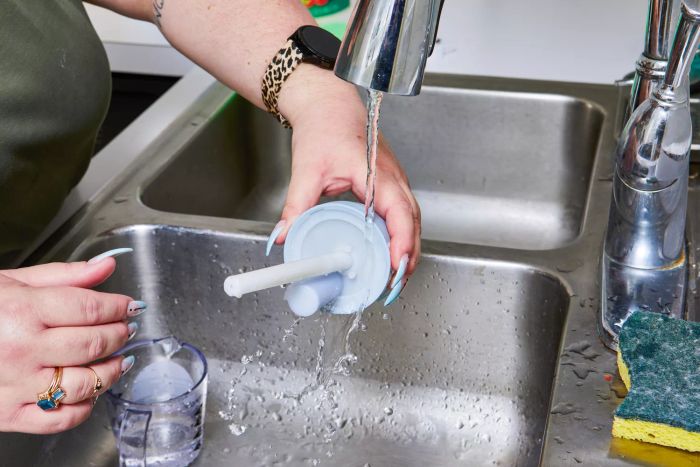 A person is cleaning the Hey Dewy Wireless Facial Humidifier
