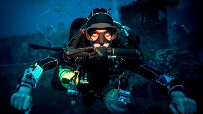 A diver exploring the ocean depths while equipped with a rebreather