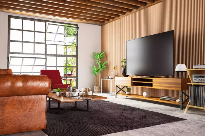 Loft featuring vertical wood paneling and large windows with multiple panes