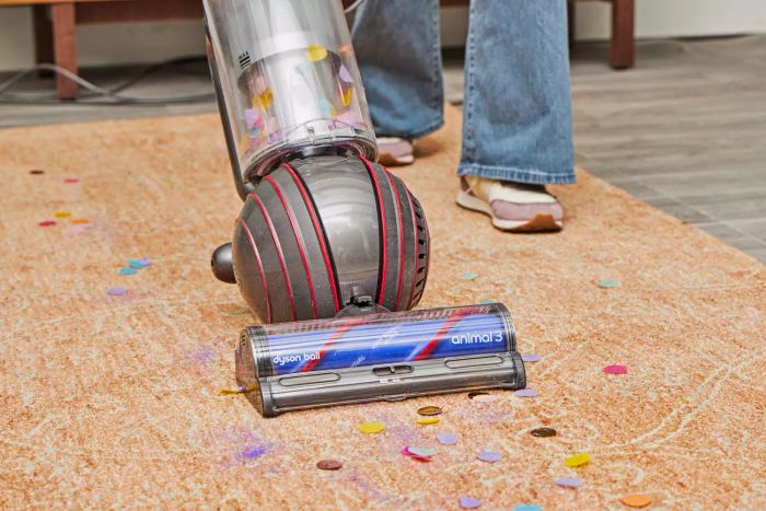A close-up shot of the Dyson Ball Animal 3 Extra picking up glitter from the floor.