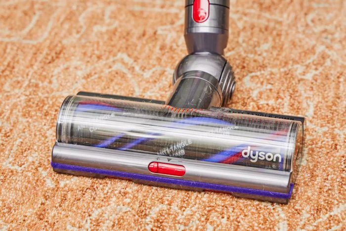 A close-up view of the Dyson V15 Detect Cordless Vacuum Cleaner on a rug