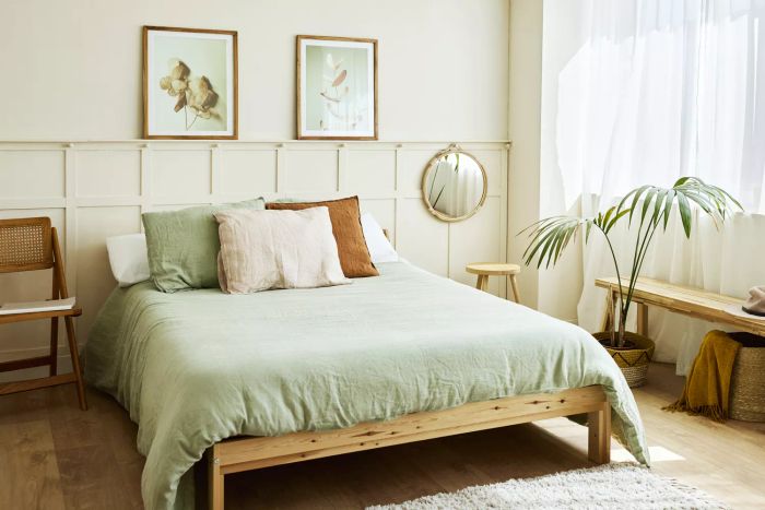 A bed with pillows arranged neatly. A bedroom's interior featuring home decor and furniture.