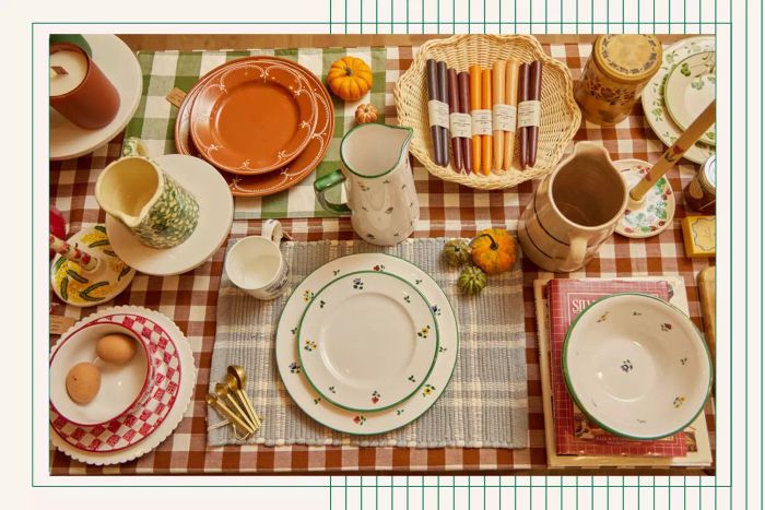 Cottagecore-inspired tablescape featuring a red plaid tablecloth, floral dishes, pumpkin decorations, and more.