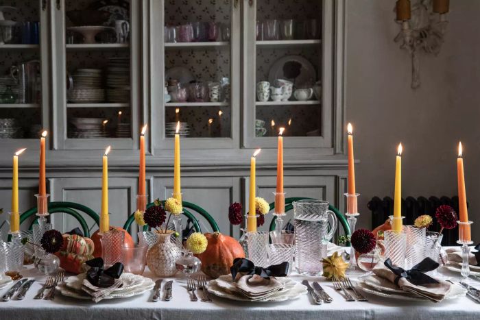 A table set with candles and place settings