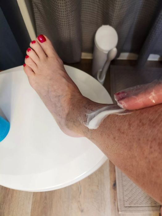 A person applies Bondi Sands Everyday Gradual Tanning Milk to their skin, creating a natural tan.
