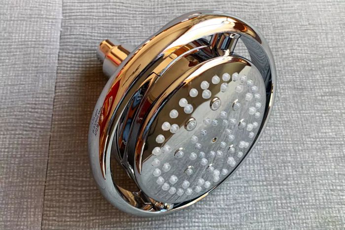 The Kohler K-15996-CP Flipside Showerhead placed on fabric