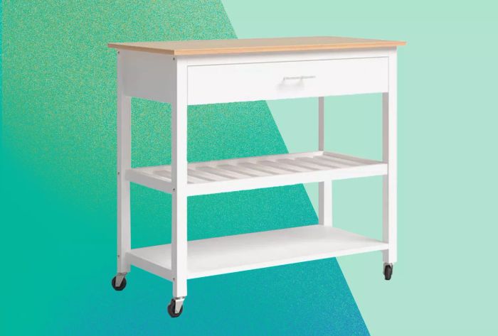 Wade Logan Aresha Wood Kitchen Island displayed on a gradient green background