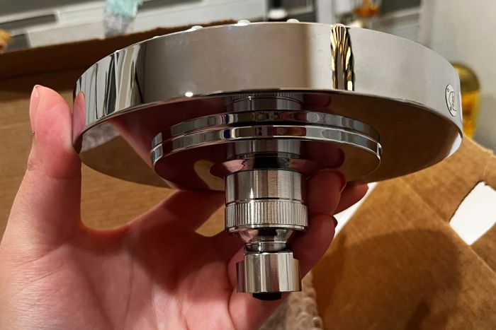 A hand holding the Hansgrohe Raindance Showerhead