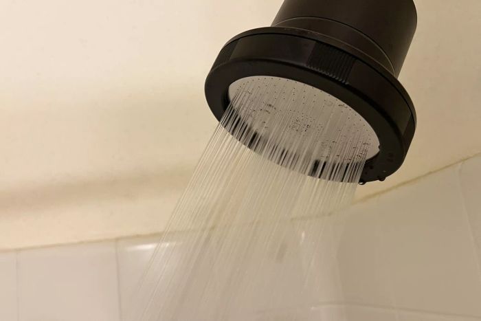 Water flowing from the Act+Acre Filtered Showerhead