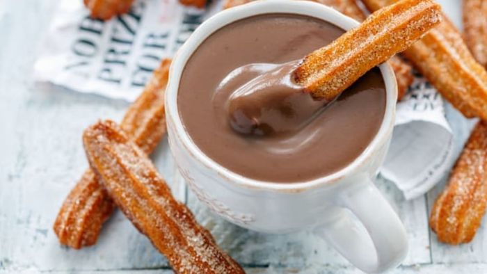 Churros served with chocolate.