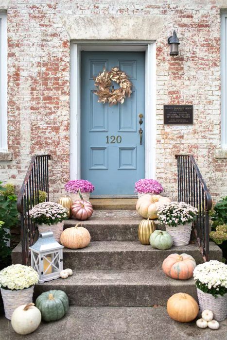 A beautifully decorated front porch with autumn touches.