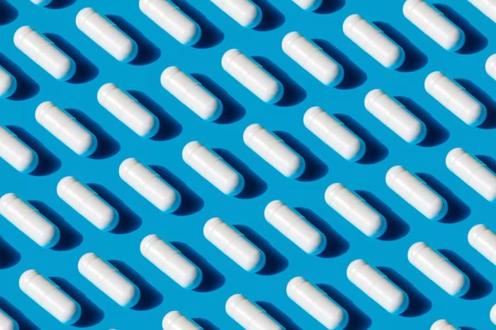 A cluster of pills on a blue surface