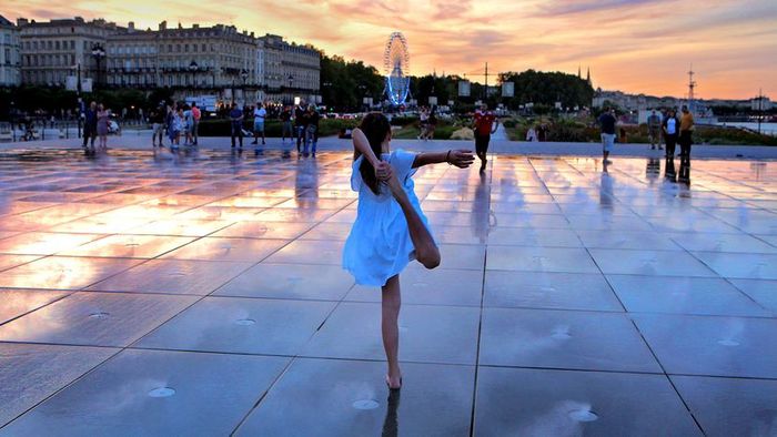 A young girl dances at Bordeaux's Water Mirror