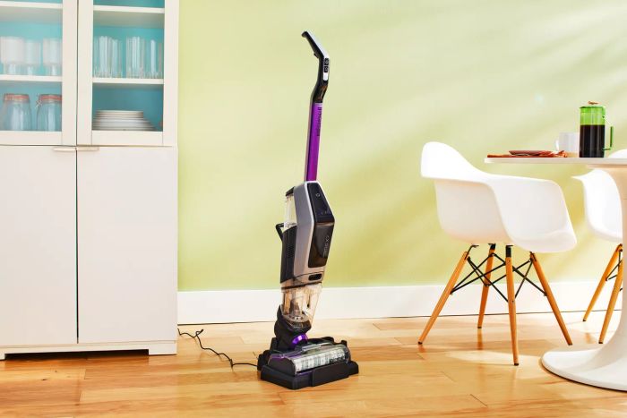 Bissell CrossWave X7 Cordless Pet Pro Multi-Surface Wet Dry Vac placed on a wooden floor next to furniture
