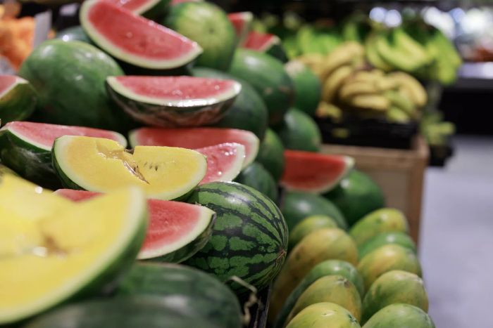 Vibrantly colored watermelons and an array of other fresh produce are staples at the grocery store, ensuring customers enjoy top-quality items for their daily meals.
