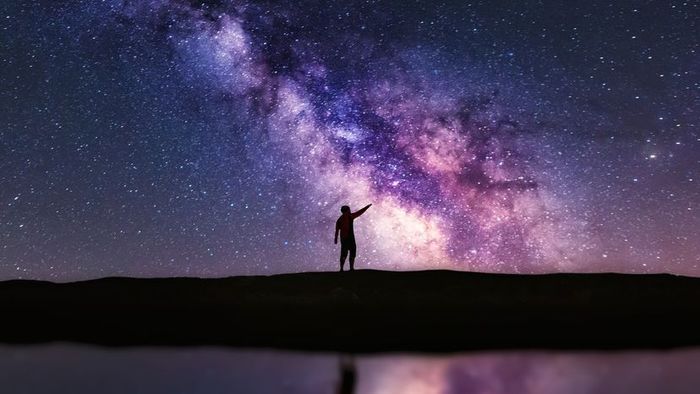 A man gazing upwards at the sky
