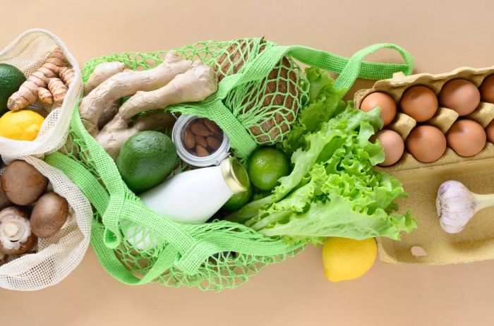 a green bag filled with groceries
