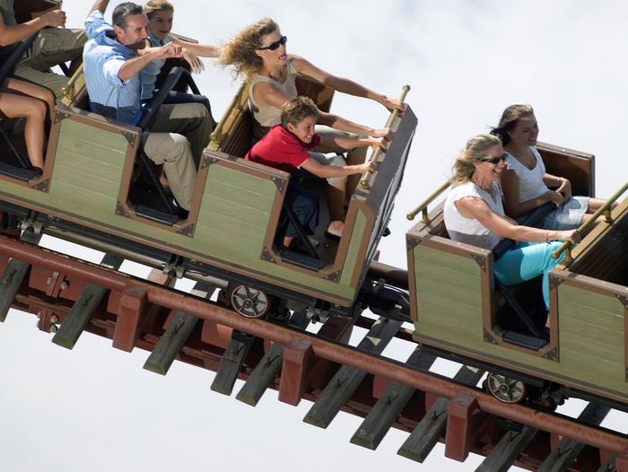Individuals enjoying a roller coaster ride