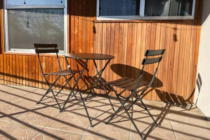 The Grand Patio 3pc Metal Folding Bistro Set displayed on a patio after assembly