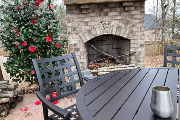 The Yardbird Lily 5-Piece Round Outdoor Dining Set placed on a patio
