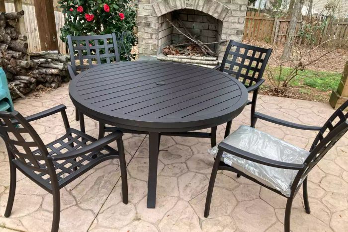 The Yardbird Lily 5-Piece Round Outdoor Dining Set displayed on a patio