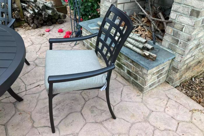 A chair from the Yardbird Lily 5-Piece Round Outdoor Dining Set on a patio