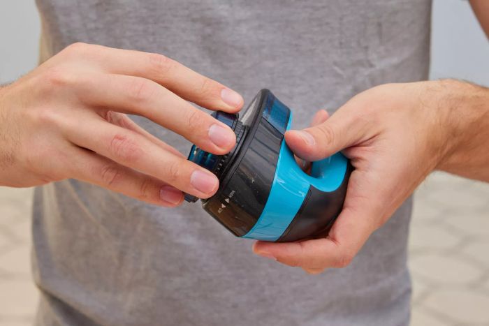 An individual operating the Rowenta Portable Lint Remover Shaver, showcasing its adjustable shave height feature.