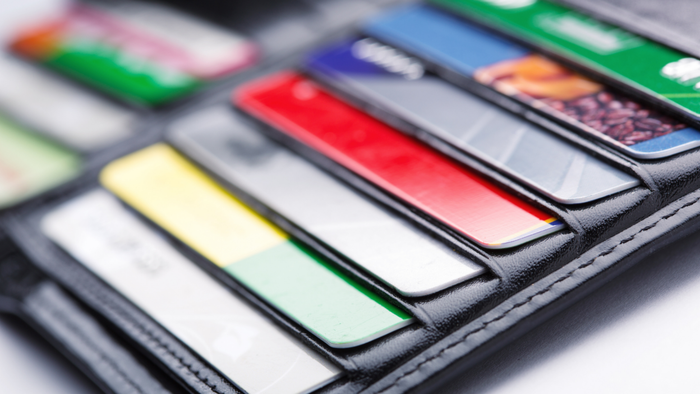 A leather wallet with credit cards partially visible