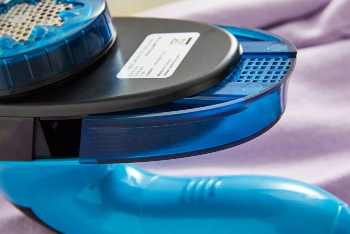 A detailed close-up view of the Rowenta Portable Lint Remover Shaver, featuring its adjustable shave height functionality.
