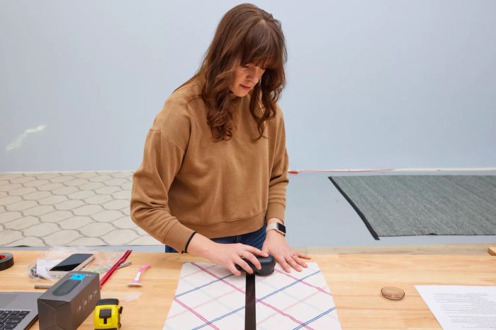 A person using the Magictec Rechargeable Fabric Shaver on fabric