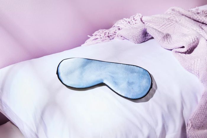 The Tim & Tina Sleep Mask resting comfortably on a pillow.