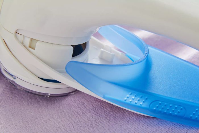 A detailed close-up of the Conair Fabric Shaver and Lint Remover