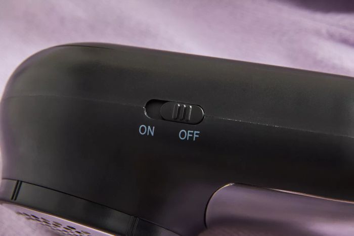 A close-up of the control switch on the Magictec Rechargeable Fabric Shaver