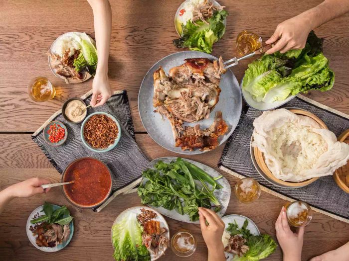 Sharing a Thai-inspired roast pork shoulder feast with a crowd.