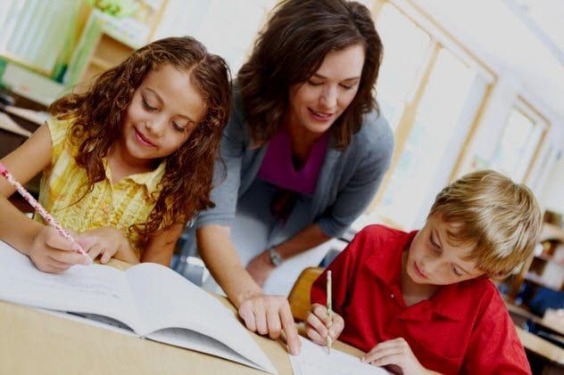 3d-teacher-correcting-students-writing-175192339