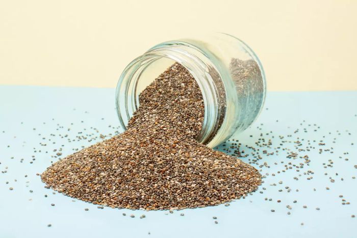 Chia seeds displayed on a vibrant blue and yellow backdrop