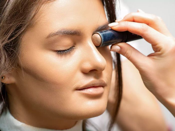 A person applying foundation to achieve the viral passport makeup look