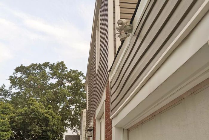 Maxsa Motion-Activated Dual Head Solar Security Light mounted on the roof of a garage