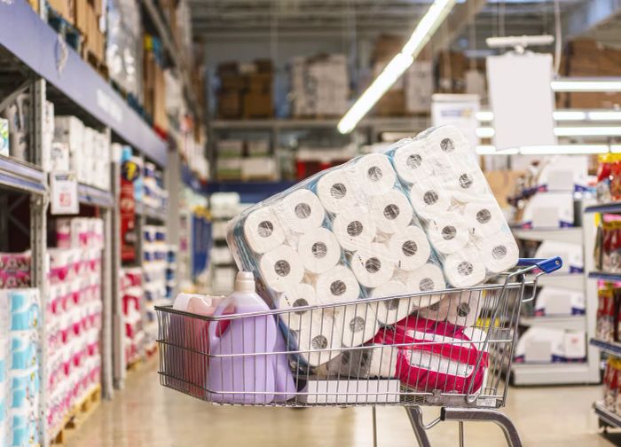 A cart brimming with toilet paper rolls
