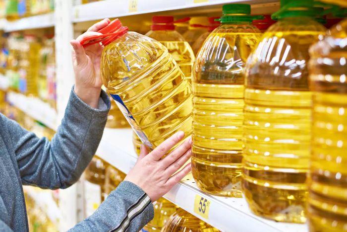 Someone purchasing a large bottle of cooking oil