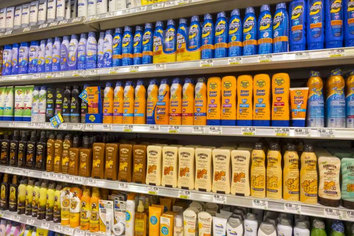 Sunscreens lined up on a supermarket shelf